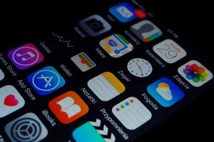 Close-up view of smartphone displaying various apps on the home screen.