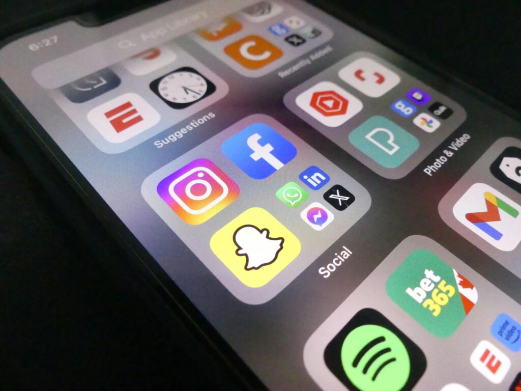 Close-up view of a smartphone screen featuring popular social media application icons.