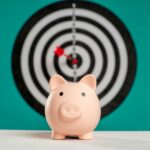 Piggy bank with bullseye dart board symbolizing financial goals and savings.