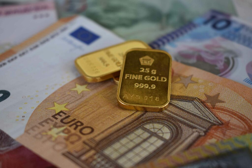 Gold bars placed on Euro banknotes representing wealth and finance concepts.