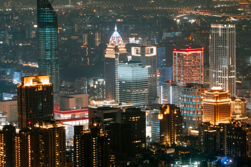 A vibrant night view of Taipei's illuminated skyline with towering skyscrapers.