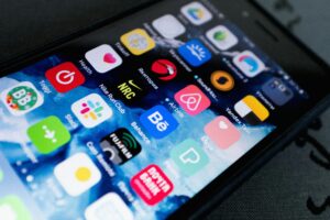 Detailed view of smartphone displaying multiple app icons on screen, highlighting technology use.