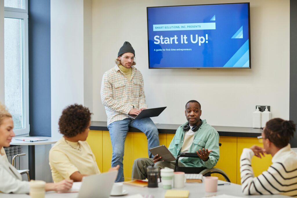 Inclusive team meeting discussing startup strategies at a modern office setting.